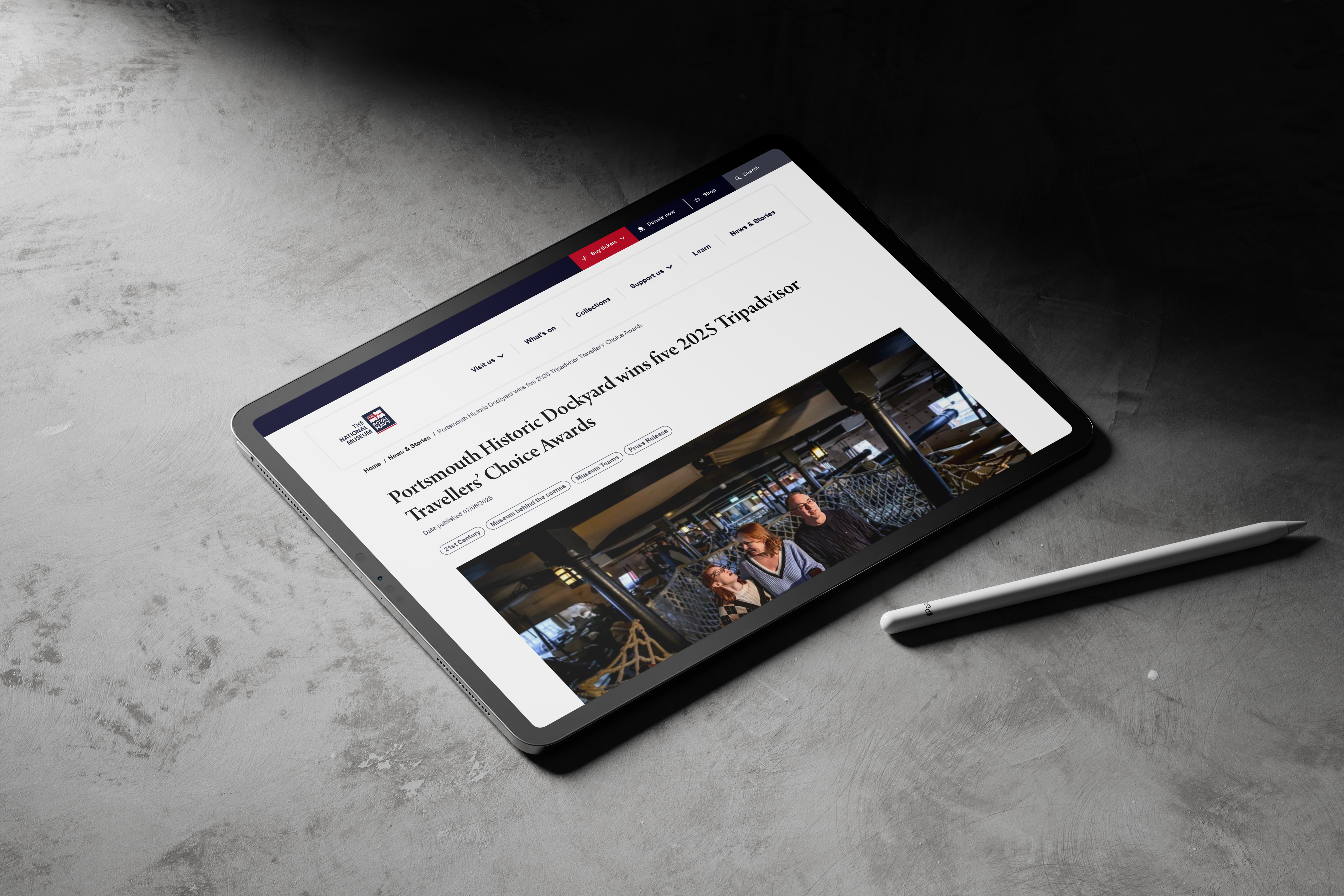 iPad on concrete background with an NMRN article on screen