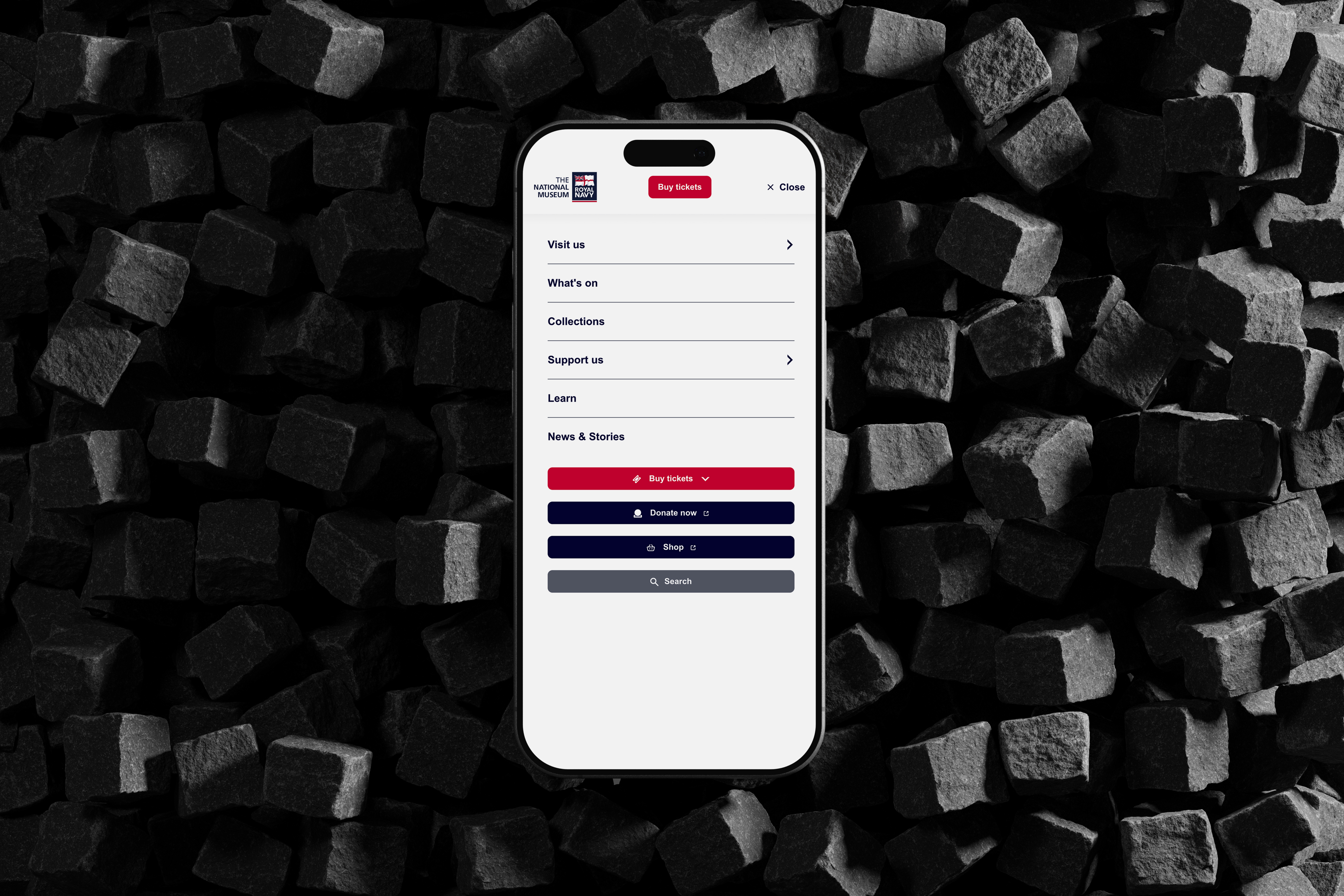 iPhone on a rubble background with the mobile menu expanded on screen