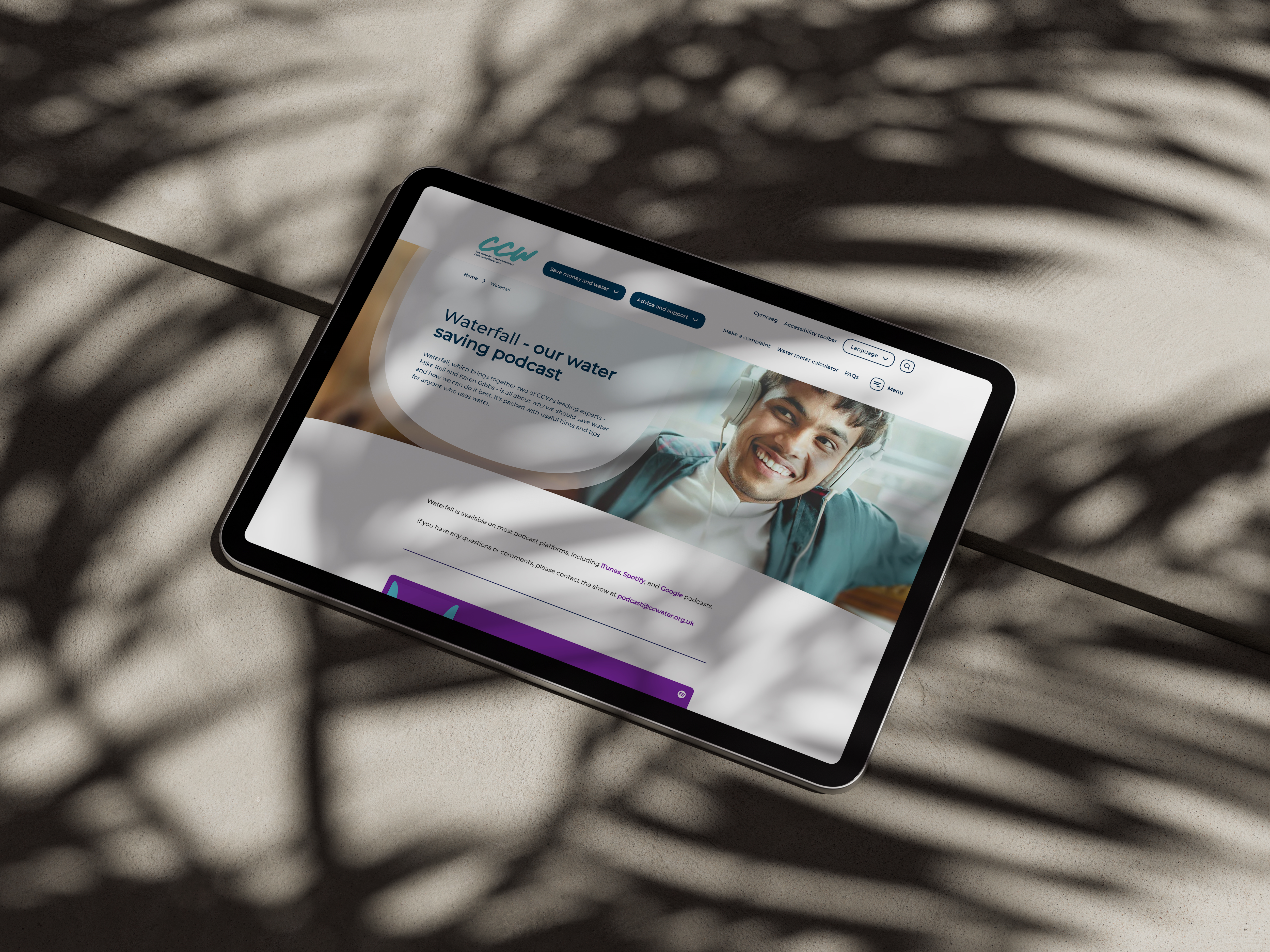 Ipad on a concrete background with the CCW podcast page on screen
