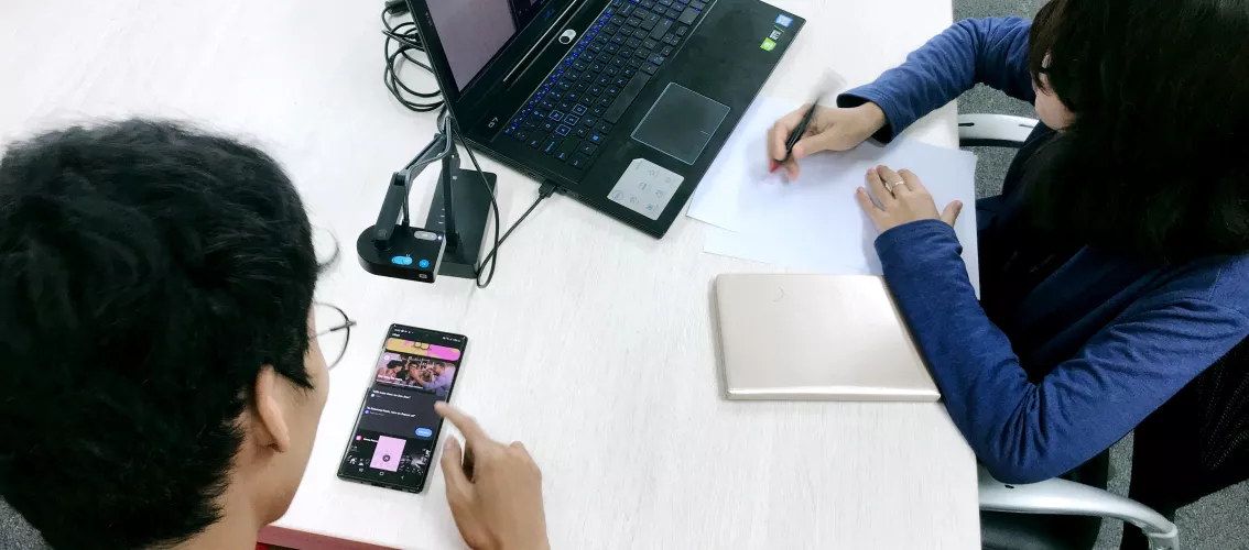 People working on their computer and mobile phones.