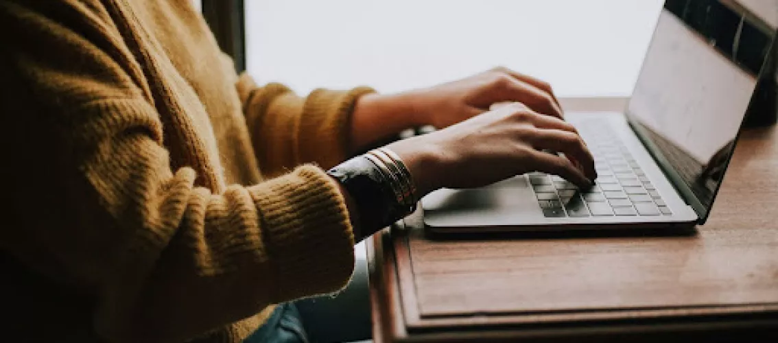 Woman typing on a laptop
