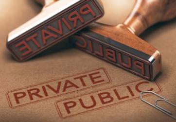 Rubber stamps labeled private and public on a brown surface