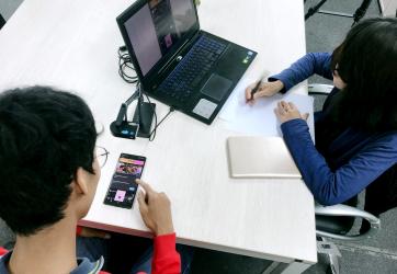 People working on their computer and mobile phones.