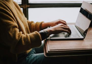 Woman typing on a laptop