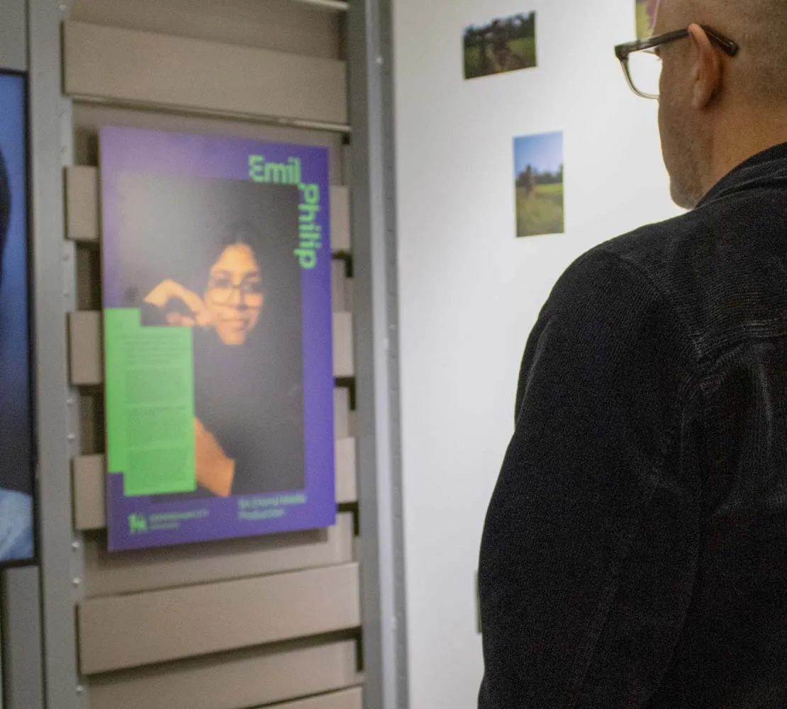 Man looking at BCU poster